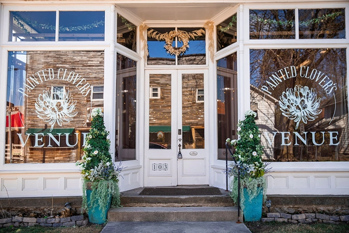 Image of out front of Painted Clover's Venue. Showing front door and front windows, with logo on the windows. Painted Clover's Venue. Haskins, Bowling Green, Perrysburg, Toledo, Whitehouse. Northwest Ohio Venue for rent.